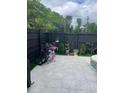 Cozy backyard featuring a tiled patio, dark wood fence, and well-maintained landscaping at 1805 Ashborough Se Cir # D, Marietta, GA 30067