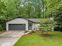 Beautifully landscaped single-story home with an attached garage and inviting front entrance at 1965 Stilesboro Nw Dr, Kennesaw, GA 30152