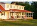 Inviting wrap-around porch with a red metal roof, perfect for enjoying outdoor living and relaxation at 4076 Airline, Mcdonough, GA 30252