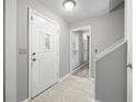 Bright foyer with tile floors, white door with decorative glass, and neutral gray walls at 4468 Whitt Station Nw Run, Acworth, GA 30101