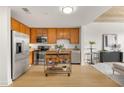 Well-lit kitchen with stainless steel appliances, wood cabinets, and open access to living area at 563 Memorial Dr # 211, Atlanta, GA 30312