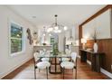 Modern dining room with stylish light fixture, seating for six, and hardwood flooring at 1221 Oakfield Se Dr, Atlanta, GA 30316