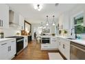 Open kitchen featuring white cabinets, stainless steel appliances, and hardwood floors at 1221 Oakfield Se Dr, Atlanta, GA 30316