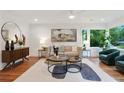 Bright living room featuring hardwood floors, neutral decor, and large windows with a lush view at 1221 Oakfield Se Dr, Atlanta, GA 30316