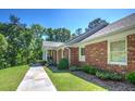 Well-maintained brick home featuring a sidewalk leading to the columned front porch at 3845 Parian Nw Rdg, Atlanta, GA 30327