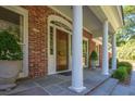 Close-up of a distinguished front door with white columns and detailed trim, adding a touch of elegance at 3845 Parian Nw Rdg, Atlanta, GA 30327