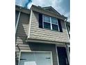 Close up of the exterior of a charming townhome featuring neutral siding and black shutters at 107 Highwood Ln, Atlanta, GA 30344