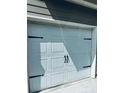 Close up of a one-car garage door on a charming townhome with black door hardware at 107 Highwood Ln, Atlanta, GA 30344