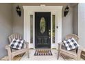 Inviting front entryway featuring a black door, side windows, and comfortable seating at 2849 Beddington Way, Suwanee, GA 30024