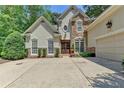 Home's front exterior shows stone facade and double front doors at 3265 Bentwood Close, Cumming, GA 30041