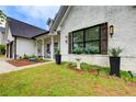 This home's exterior boasts beautiful windows with shutters and manicured landscaping at 51 Norton Ave, Acworth, GA 30101