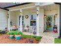 Inviting front porch area is furnished with rocking chairs and stylish decor at 51 Norton Ave, Acworth, GA 30101