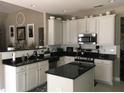 Well-lit kitchen featuring granite countertops, stainless steel appliances, and a central island at 51 Norton Ave, Acworth, GA 30101