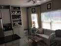 Inviting living room with a comfortable sofa, built-in shelving, and a large window providing natural light at 51 Norton Ave, Acworth, GA 30101