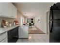 Bright kitchen featuring granite countertops, white cabinets, and stainless steel dishwasher at 6351 Stablewood Way, Lithonia, GA 30058