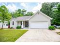 Charming single-story home featuring an attached garage, manicured lawn, and inviting curb appeal at 9691 Squirrel Wood Run, Douglasville, GA 30135