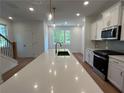 Bright kitchen featuring a large island, modern appliances, and a view of the backyard at 1932 Appian Aly, Kennesaw, GA 30144