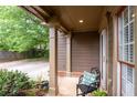 Cozy front porch with view of driveway, decorative pillars, and seating area at 238 Ivy Glen Cir, Avondale Estates, GA 30002