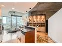 Modern kitchen features an island with bar seating and updated stainless steel appliances at 400 W Peachtree Nw St # 2614, Atlanta, GA 30308