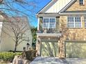 View of the townhome and front driveway, and its yellow neighbor to the left at 2540 Willow Grove Road Rd, Acworth, GA 30101
