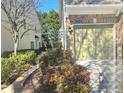 Exterior view of townhome featuring a garage and manicured landscaping at 2540 Willow Grove Road Rd, Acworth, GA 30101