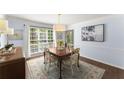 Dining room featuring hardwood floors, a large window, blue walls, and classic decorative furniture at 4295 Parish Trce, Marietta, GA 30066
