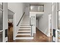 Inviting foyer featuring hardwood floors, staircase with a wood handrail, and views to other living spaces at 4295 Parish Trce, Marietta, GA 30066