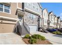 A row of townhomes showcases the front exterior and attached garages with landscaping and inviting curb appeal at 2517 Hedgeway Cir, Kennesaw, GA 30144