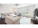 Bright living room with high ceilings, large windows, and stylish decor offers a view of the neighborhood at 2517 Hedgeway Cir, Kennesaw, GA 30144