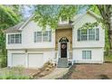 Attractive two-story home featuring a stone facade, white siding, and well-maintained landscaping at 3140 Willow Park Dr, Dacula, GA 30019