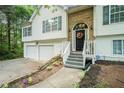 Inviting front entrance featuring a decorative door, stone accents, and landscaped walkway at 3140 Willow Park Dr, Dacula, GA 30019