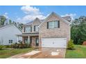 Inviting two-story brick home with an attached garage and a well-manicured front lawn at 328 Orchid Dr, Mcdonough, GA 30252