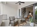 Relaxing covered patio featuring comfortable seating, a ceiling fan, and seamless indoor-outdoor flow at 613 Stickley Oak Way, Woodstock, GA 30189