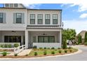 Charming two-story home with a covered porch, manicured lawn, and inviting curb appeal at 613 Stickley Oak Way, Woodstock, GA 30189