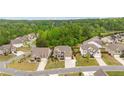 An aerial view of a neighborhood showcasing houses with well-maintained lawns and landscaping at 7730 Tiberon Pkwy, Cumming, GA 30028