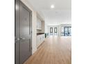 Hallway view into the bright living room showcasing built in cabinets and an open floor plan at 1100 Howell Mill Nw Rd # 505, Atlanta, GA 30318