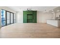 Spacious open floor plan with modern green built-ins, balcony and sleek countertops in the adjacent kitchen at 1100 Howell Mill Nw Rd # 505, Atlanta, GA 30318