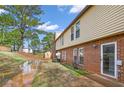 View of the backyard with a brick exterior and grassy area near standing water at 3162 Citrus Ct, Decatur, GA 30034