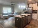 Open-concept kitchen featuring a center island and stainless steel appliances at 243 Beau St, Lilburn, GA 30047