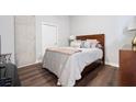 Cozy bedroom with a wood-framed bed, hardwood floors, and neutral decor at 3300 Windy Ridge Se Pkwy # 1212, Atlanta, GA 30339