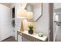 Hallway features modern console table with decor and a laundry closet at 3300 Windy Ridge Se Pkwy # 1212, Atlanta, GA 30339