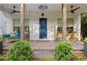 Inviting front porch with swing, rocking chairs, and stylish brick flooring at 676 Juneberry Se Ln, Atlanta, GA 30316