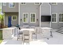 Well-equipped outdoor kitchen with built-in grill, countertop seating, and a wall-mounted television at 1446 Wilford Ne Dr, Atlanta, GA 30319