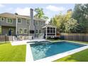 Inviting backyard featuring a large swimming pool, outdoor kitchen, seating, and well-maintained lawn at 1446 Wilford Ne Dr, Atlanta, GA 30319