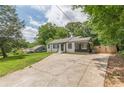 Cozy single-story home with a long driveway, surrounded by lush greenery at 3311 Lavista Dr, Hapeville, GA 30354