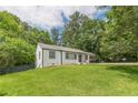 Charming single-story home with a well-maintained lawn surrounded by lush trees at 3311 Lavista Dr, Hapeville, GA 30354