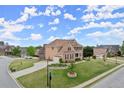Corner lot home with an expansive lawn, long driveway, and traditional brick facade at 4605 Heathcliff Way, Cumming, GA 30041