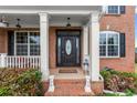 Elegant front entry featuring a detailed door, sidelights, and brick steps at 4605 Heathcliff Way, Cumming, GA 30041