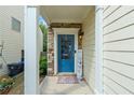 Inviting front entrance with a blue door, stone accents, and a 'Welcome HOME' sign at 6065 Falls Landing Dr, Cumming, GA 30040