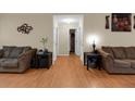 Open living room features hardwood floors, neutral colors, and access to hallways at 10 Mcgiboney Pl, Covington, GA 30016